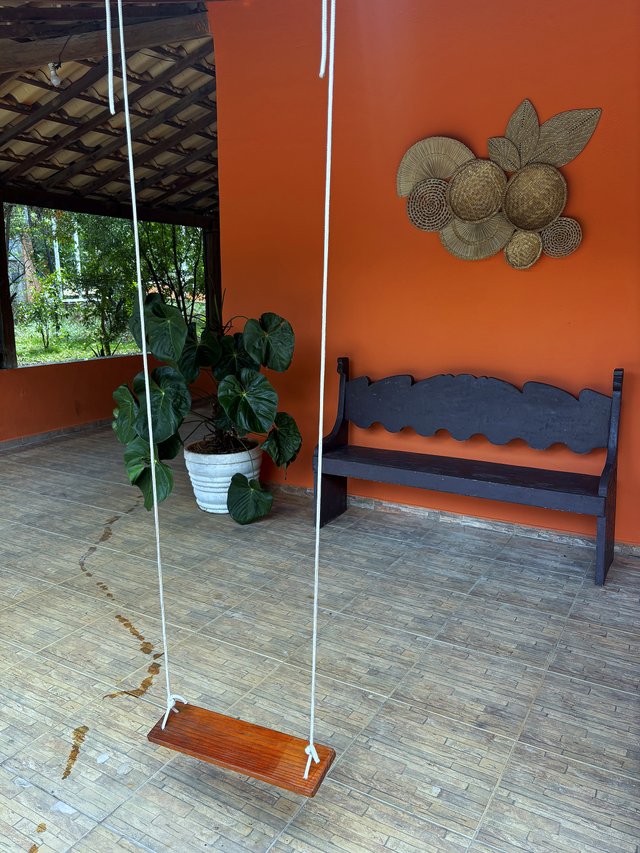 Exterior — Varanda lateral com poltrona e janelas